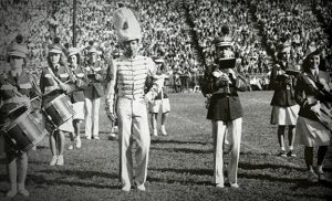 Members of the 1945 band standing on a football field.
