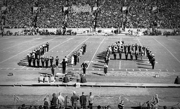 The Million Dollar Band on the football field, forming the letters "U" and "A."