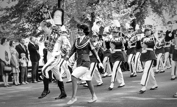 Miss Alabama Carol Self and drum major Bill Fuqua march at the head of the band for the 1964 homecoming parade.
