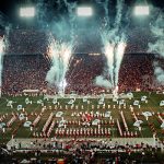 View of the band performing in Bryant-Denny Stadium amid fireworks.