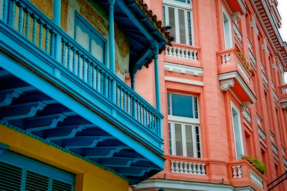 Two brightly colored buildings in Havana, Cuba.