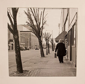 Photo of woman walking down street.