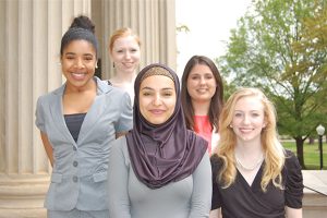 Ashley Smith (second from left), Hailah Saeed (center), and Grace Spears (right), earned UA Study Away scholarships to continue their studies this summer. They are pictured with two other UA Away scholarship recipients.