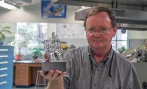 Rick Smith with a glass elephant that he has created