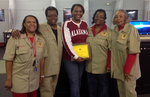 Dr. Rosianna Gray (pictured at center), an assistant professor in the Department of Biological Sciences, is presented with a certificate of appreciation from (left to right) Delitha McTerry, Annette Taylor, Jennette Grant, and Catherine Spencer, members of the Daughters of Isis contributions to their annual holiday tor drive.