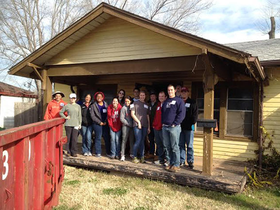 UA students stand in front of a house they renovated in Moore, Oklahoma, for tornado survivors.