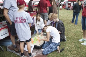 Children dig for fossils at the A&S homecoming tent.