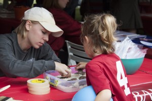 A child learning about fossils at the A&S homecoming tent.