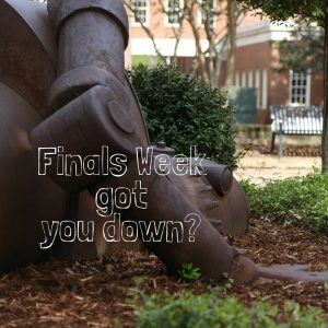 fallen robot statue with the words "Finals week got you down"