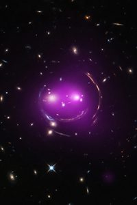 The x-ray image superimposed over the optical image creates the purplish smile of The Cheshire Cat Galaxy Group.