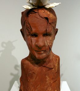 brick-red sculpture of a human head