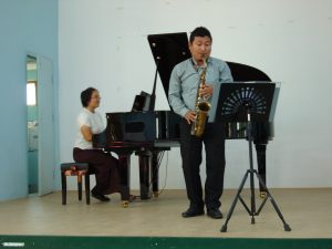 Ten Yeen accompanies her colleague Aung at a concert they organized for Dr. Joanna Biermann.
