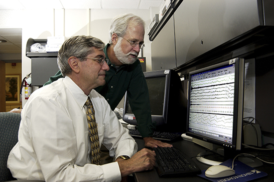 Dr. Kenneth Lichstein (left) and Dr. Sid Nau (right) review the electronic record of a patient's polysomnography.