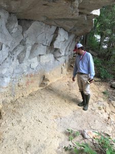 Matthew Gage, director of the UA Office of Archaeological Research, stands on a paleoflood deposit on a bluff of the Tennessee River.