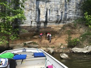 Dr. Gary Stinchcomb, of Murray State University, right, and Dr. Matthew Therrell, of The University of Alabama, examine a paleoflood deposit trapped under a rock overhang on a bluff of the Tennessee River.