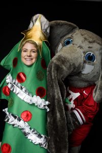 student in a Christmas tree costume next to Big Al