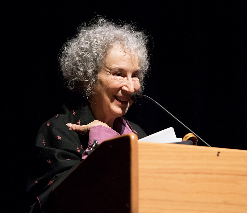 Margaret Atwood standing at a podium, smiling