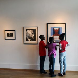 three kids studying a painting at the Paul Jones Museum