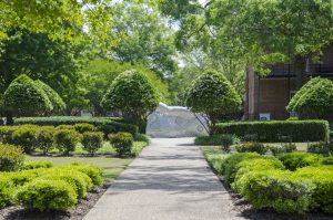 sidewalk leads to a sculpture in the Woods Quad Sculpture Garden