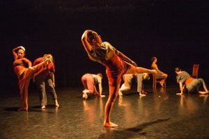 seven students dance on stage