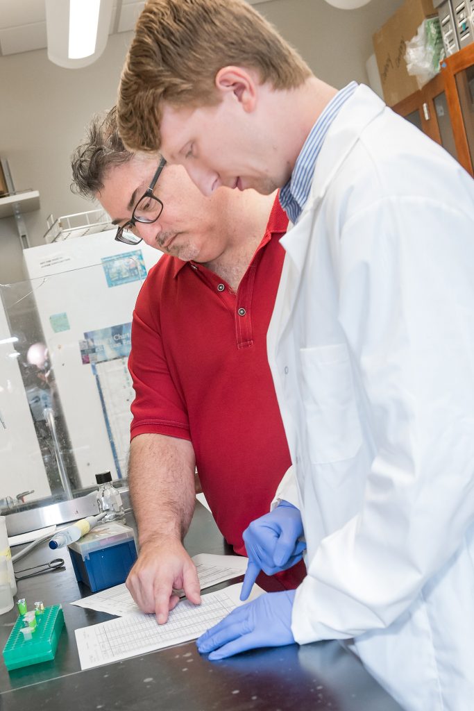 Dr. Guy Caldwell, left, and doctoral student Brucker Nourse are studying genetic resiliency to Parkinson’s.