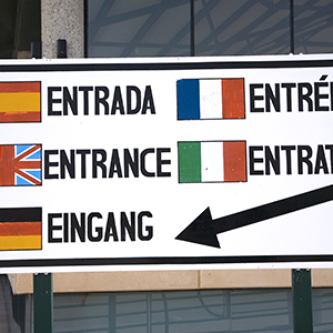 a sign that reads entry in five different languages
