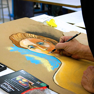 a student drawing a portrait