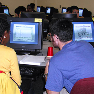 two students working together in a computer lab