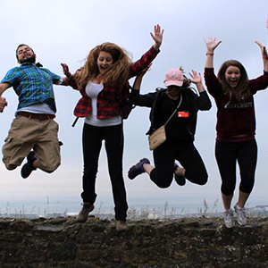 a group of students jumping in the air in unison