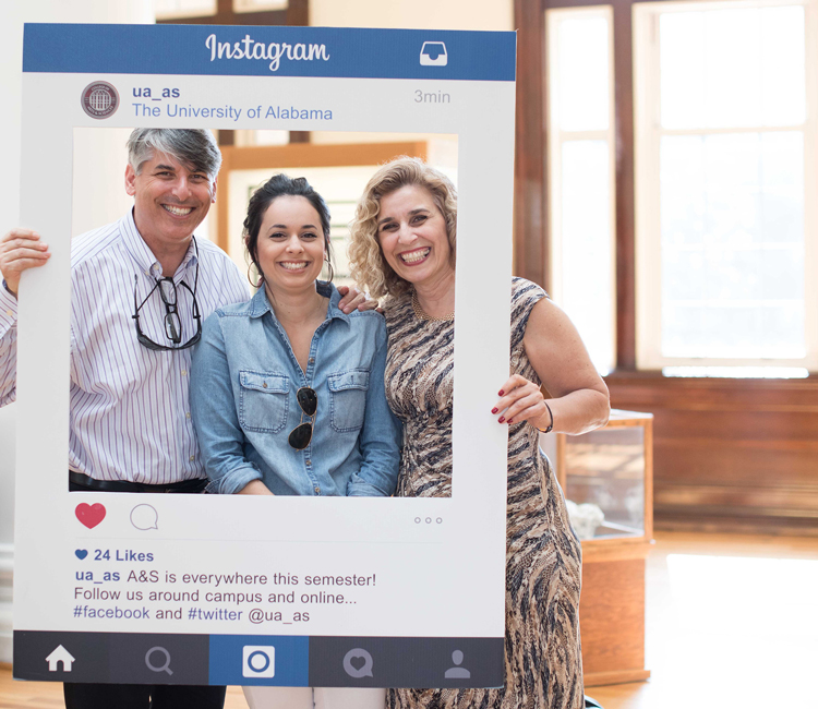 student and parents posing with an Instagram-style frame