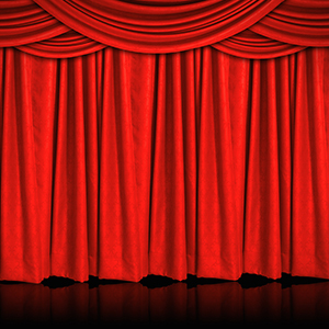 a stage, with closed red curtains