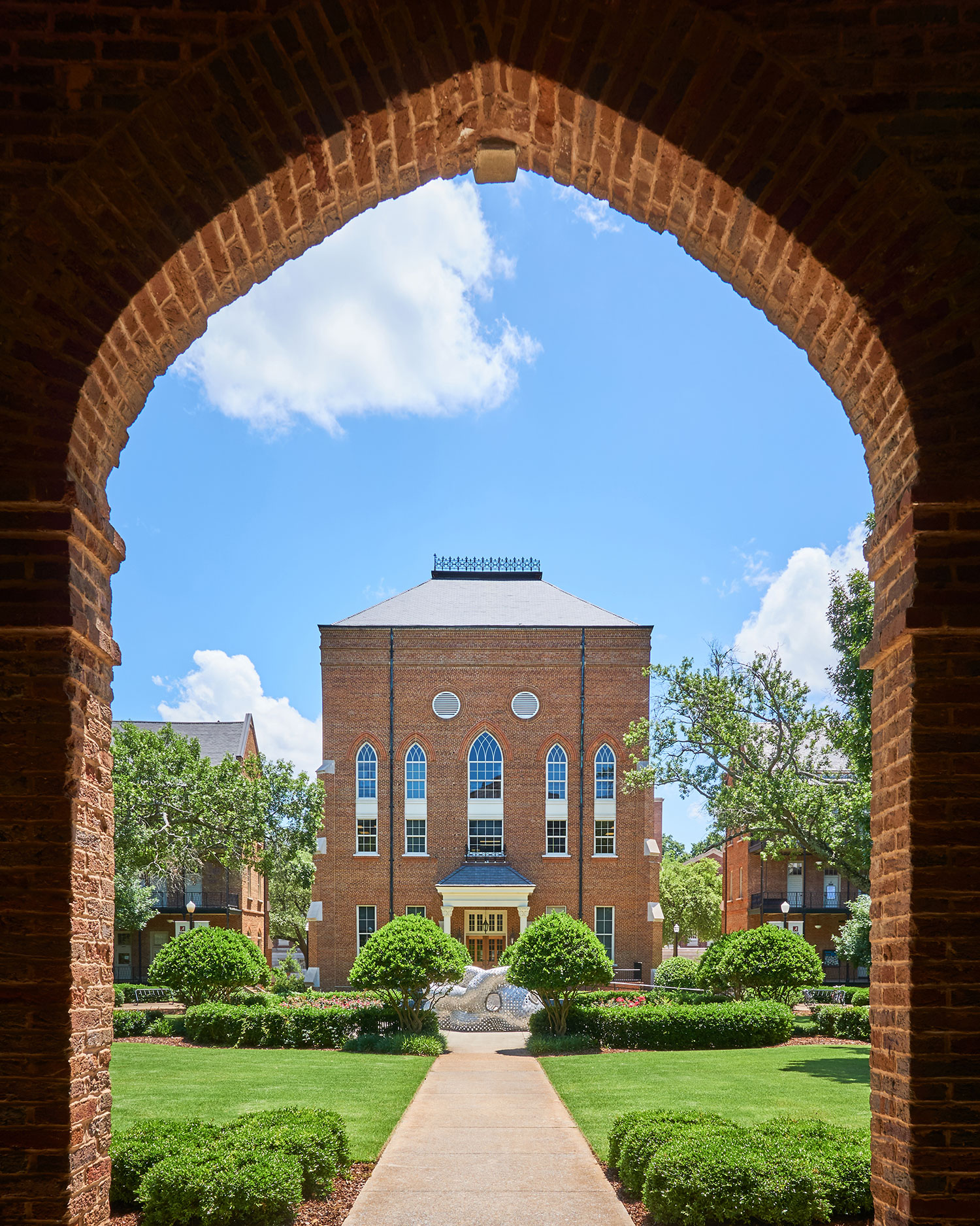 the back of Clark Hall, viewed through an archway on the first floor of Woods Hall