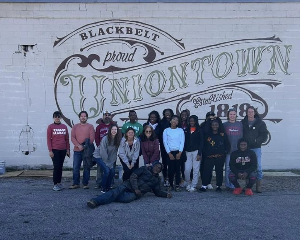 Engage Alabama group in front of mural in Uniontown