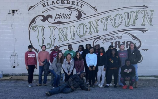 Engage Alabama group in front of mural in Uniontown