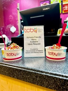 TCBY dessert in front of a "Aphasia Friendly Menu Available Upon Request"