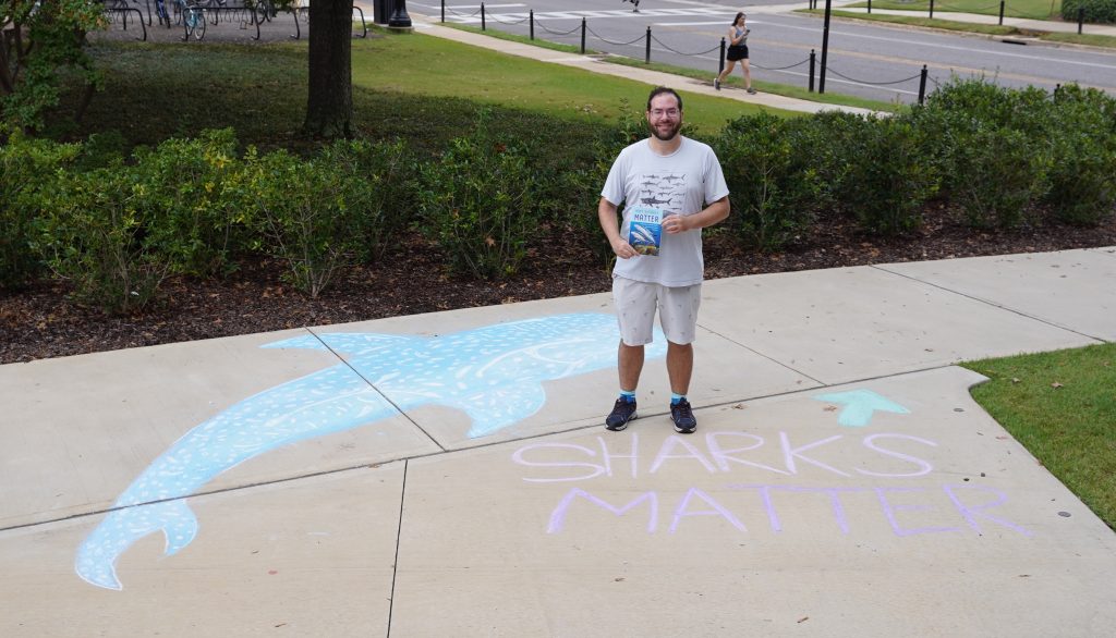 Shiffman standing with Sharks Matter Chalk Art