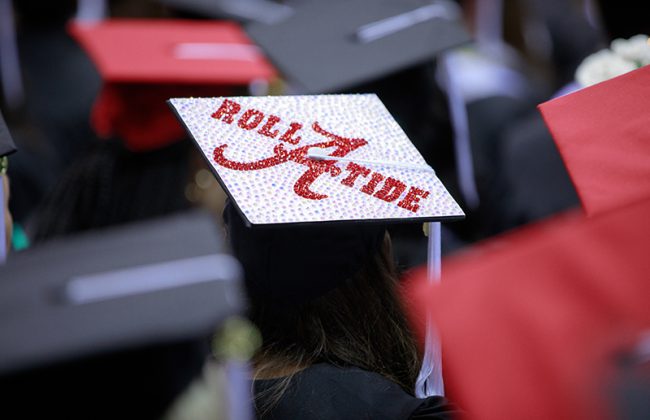 graduation cap decorated with the University of Alabama script A logo and the words Roll Tide
